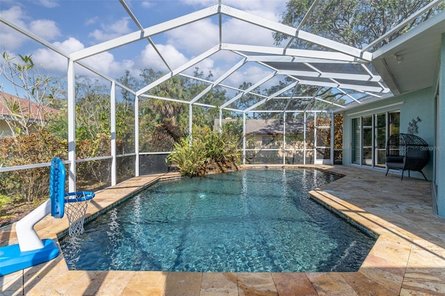 pool with a lanai and a patio area