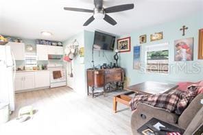 living area with ceiling fan and light wood finished floors