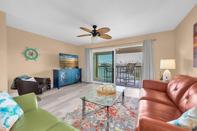 living room with ceiling fan and wood finished floors