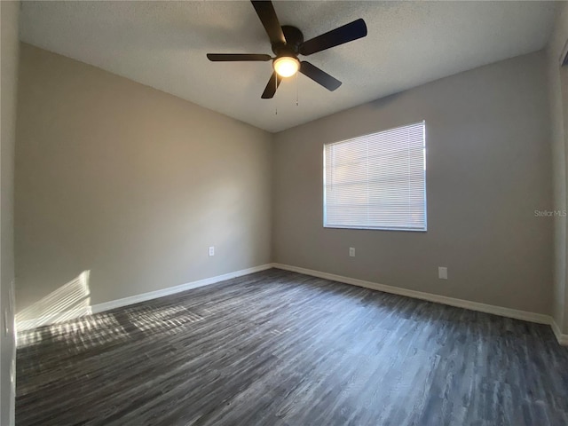 unfurnished room with dark wood-type flooring, a textured ceiling, baseboards, and a ceiling fan