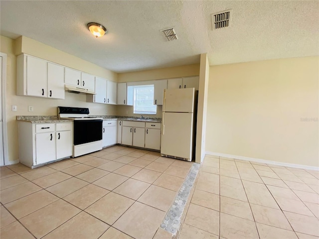 kitchen featuring white appliances, under cabinet range hood, visible vents, and a sink