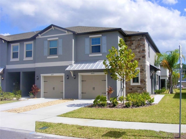 view of front of home with a front yard, stone siding, metal roof, and a standing seam roof