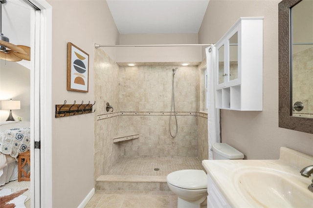 full bathroom with a tile shower, vanity, toilet, and tile patterned floors