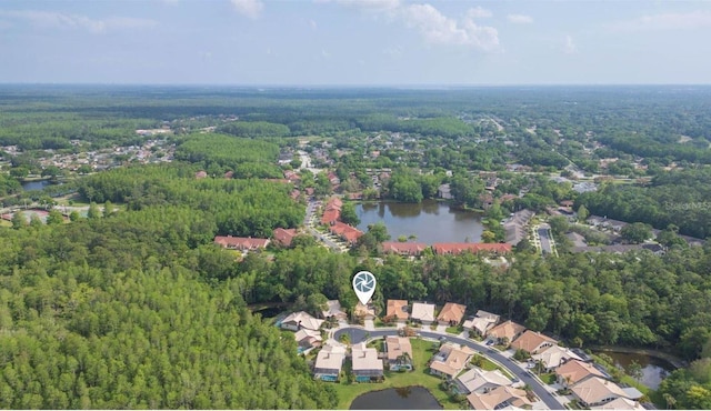 birds eye view of property featuring a water view and a view of trees