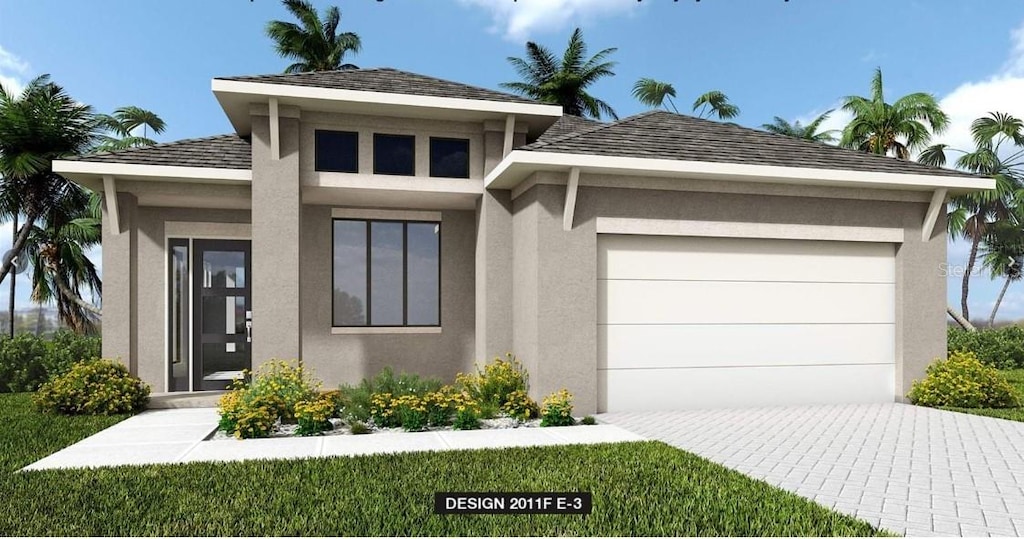 view of front facade featuring decorative driveway, an attached garage, and stucco siding