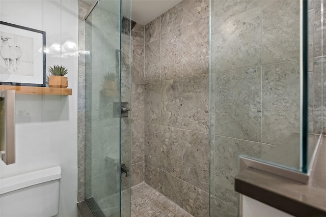 bathroom with toilet and a shower stall