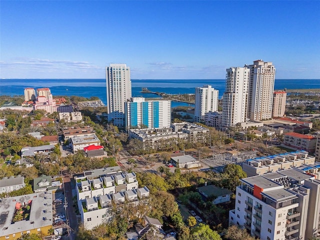 birds eye view of property with a water view and a city view