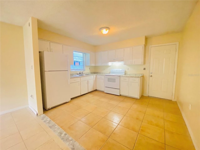 kitchen with baseboards, light countertops, white cabinets, white appliances, and a sink