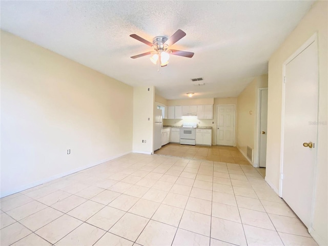 unfurnished living room featuring light tile patterned floors, visible vents, a textured ceiling, and ceiling fan