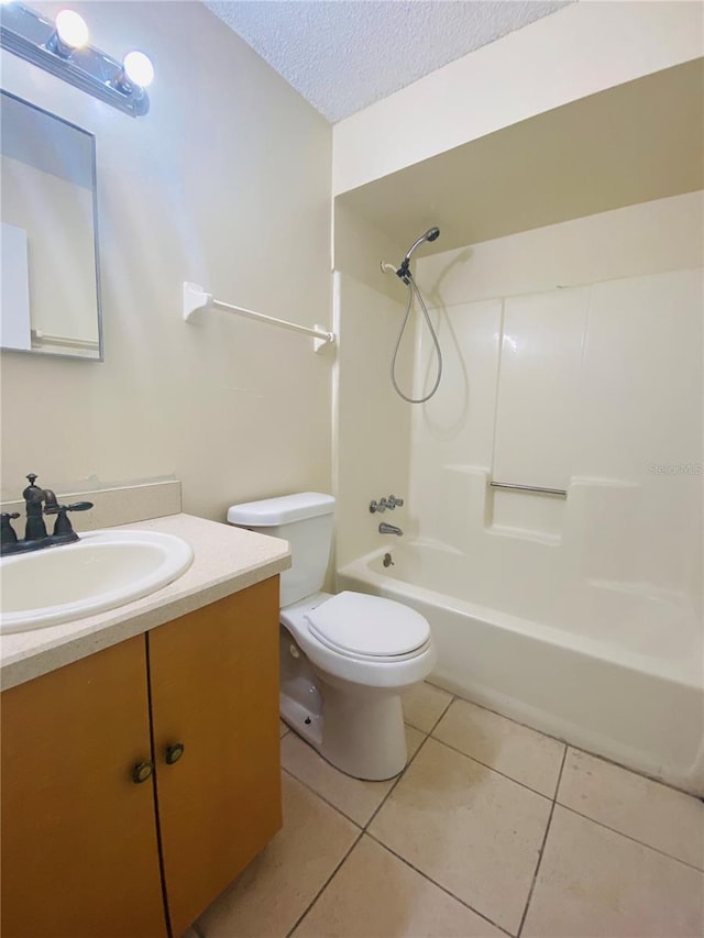 full bathroom featuring tile patterned floors, toilet, a textured ceiling, tub / shower combination, and vanity