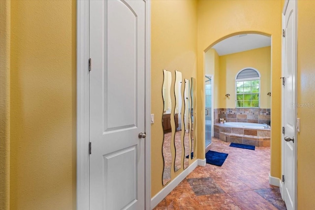 full bathroom featuring a stall shower and a garden tub