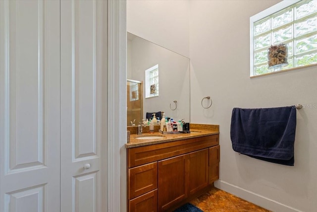 full bath with tile patterned floors, a shower stall, vanity, and baseboards