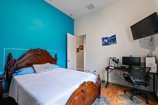 bedroom with baseboards and visible vents