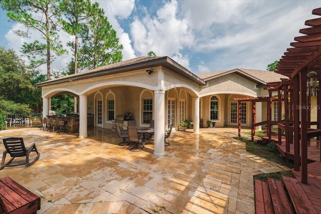 view of patio with outdoor dry bar and french doors