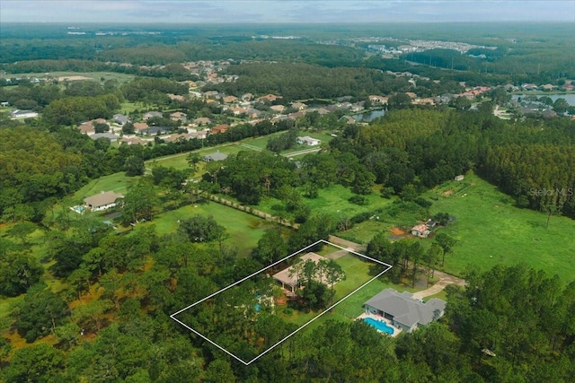 birds eye view of property with a view of trees