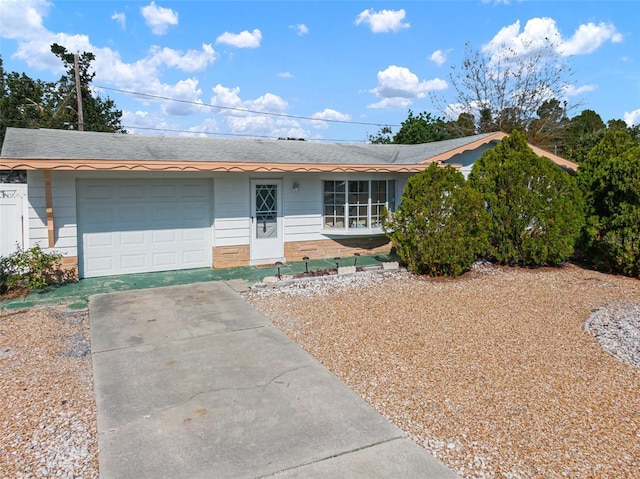 ranch-style home with an attached garage and driveway