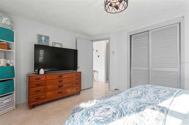 bedroom featuring light speckled floor and a closet