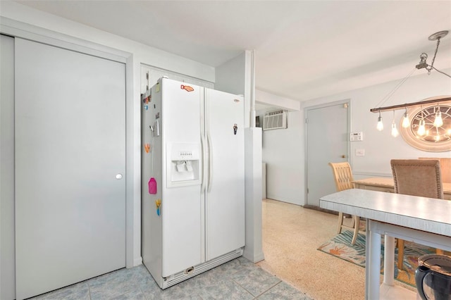 kitchen with white refrigerator with ice dispenser and a wall mounted AC