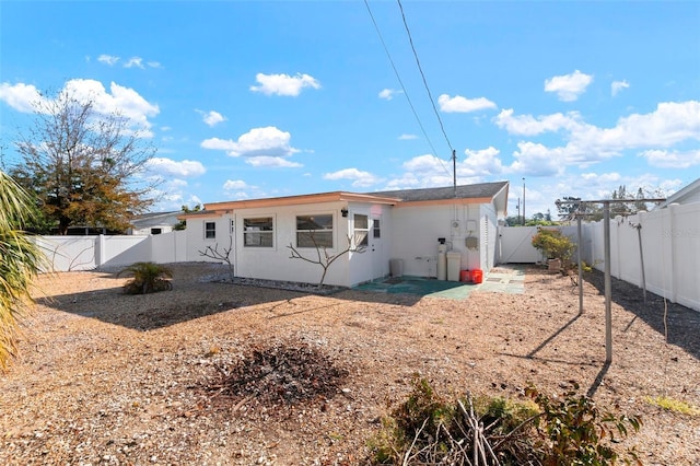 back of house with a fenced backyard