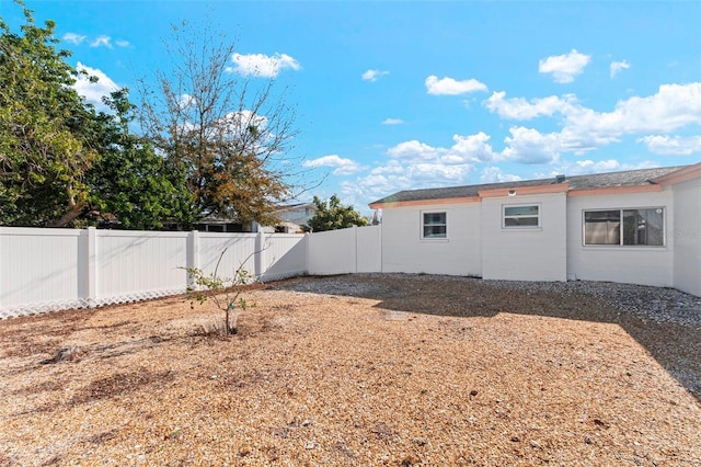 rear view of property with a fenced backyard