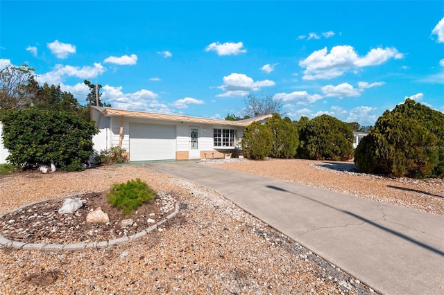 ranch-style home featuring an attached garage and concrete driveway