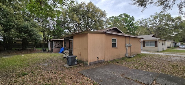 view of home's exterior with cooling unit and fence