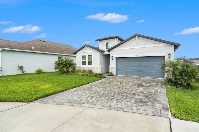 view of front of home with stone siding, stucco siding, an attached garage, decorative driveway, and a front yard