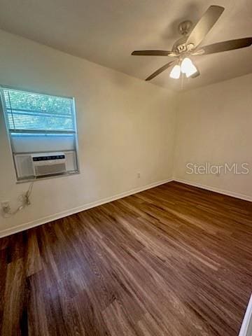 unfurnished room featuring ceiling fan, cooling unit, wood finished floors, and baseboards