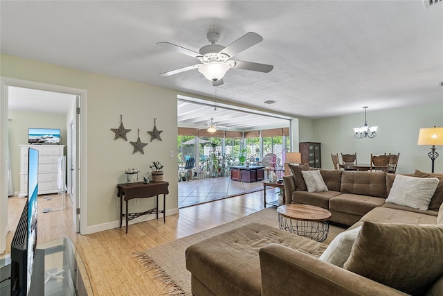 living area featuring light wood-style floors, baseboards, visible vents, and a chandelier