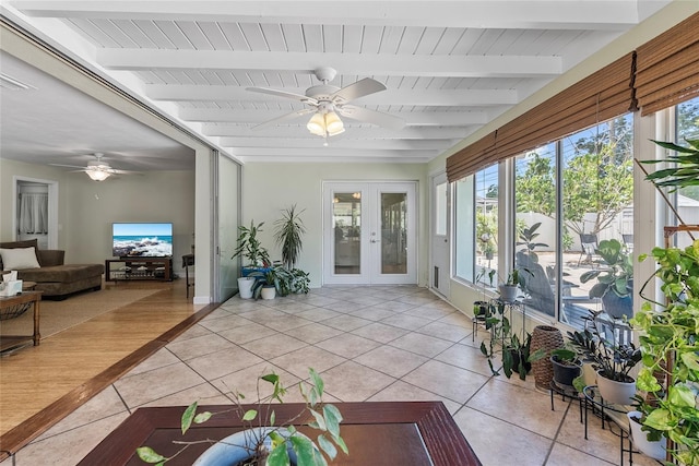 sunroom / solarium with french doors, a healthy amount of sunlight, and beamed ceiling