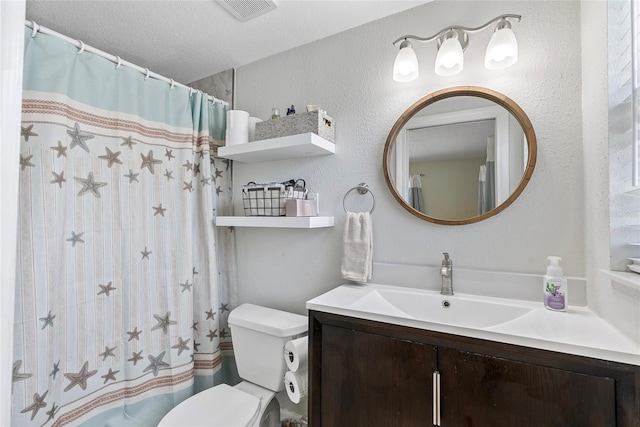 bathroom featuring toilet, curtained shower, visible vents, and vanity