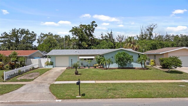 single story home featuring an attached garage, driveway, a front lawn, and fence