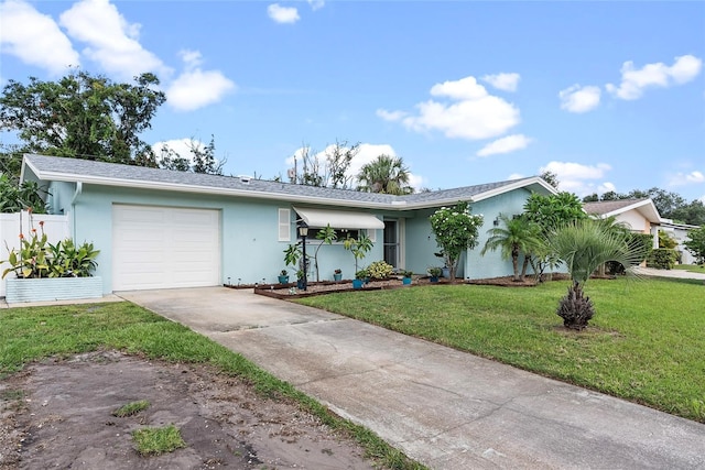 ranch-style house featuring an attached garage, fence, concrete driveway, stucco siding, and a front yard