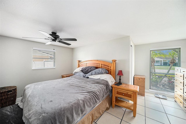 bedroom with ceiling fan and light tile patterned floors