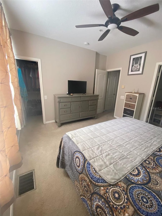 bedroom with visible vents, ceiling fan, light carpet, and baseboards