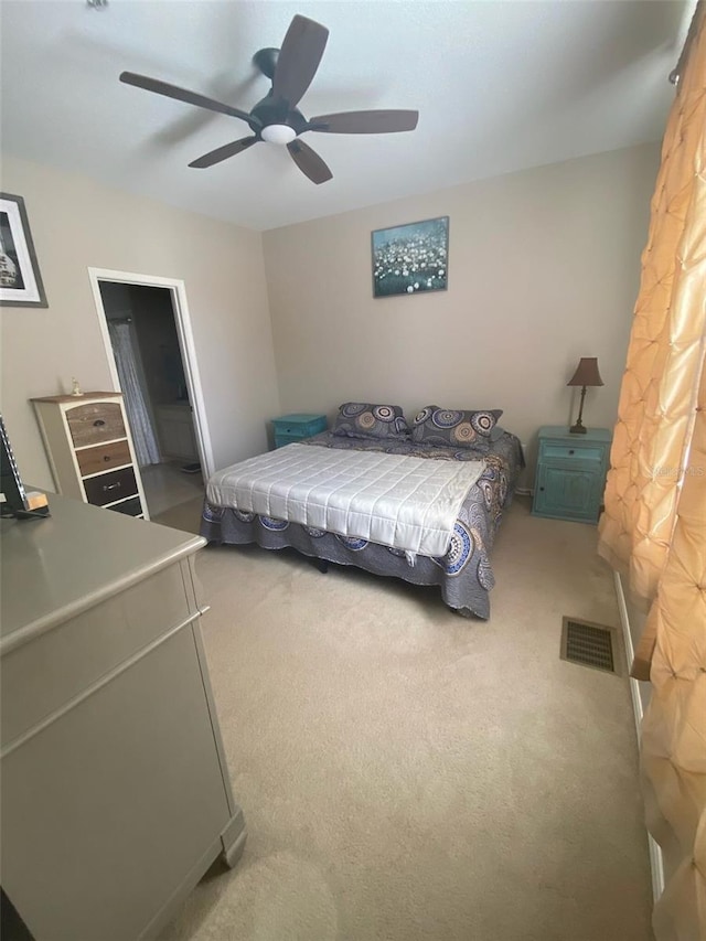 carpeted bedroom with ceiling fan and visible vents