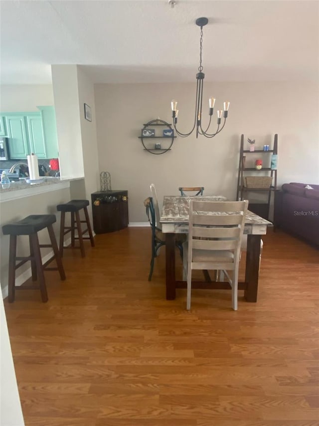 dining area featuring a chandelier and light wood-type flooring