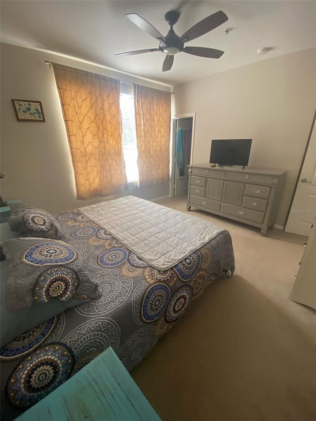 bedroom with ceiling fan and light colored carpet