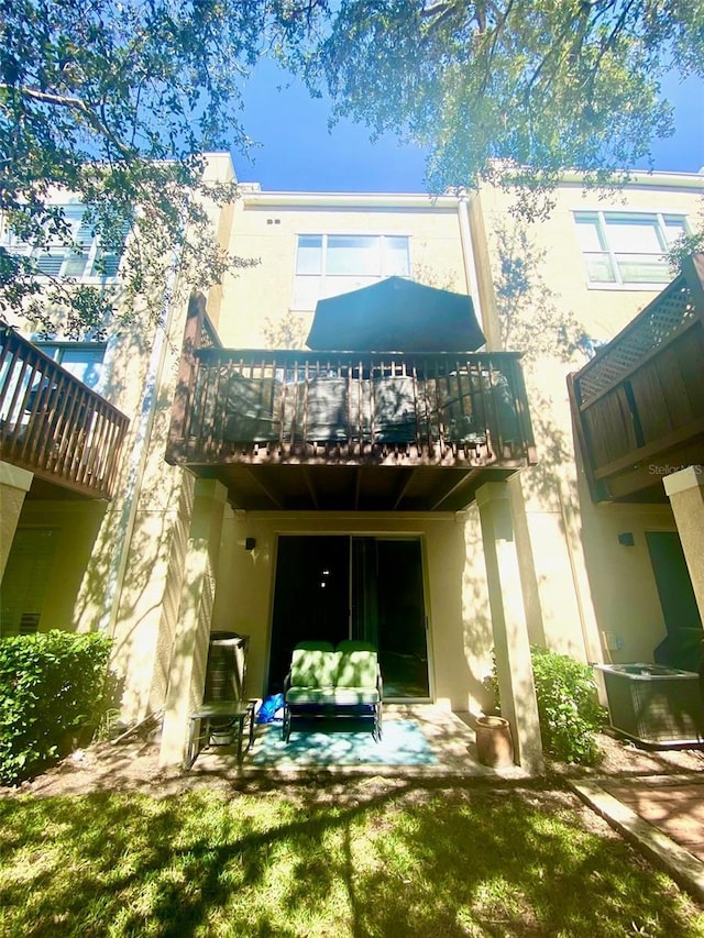 rear view of house with stucco siding