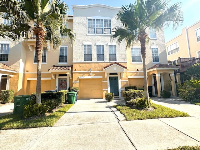 3128 Bayshore Oaks Dr, Tampa, FL 33611 - multi unit property with a garage, stucco siding, driveway, and a tiled roof