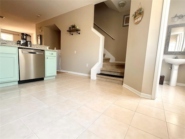 3128 Bayshore Oaks Dr, Tampa, FL 33611 - kitchen featuring stainless steel dishwasher, light tile patterned floors, light stone counters, and green cabinetry