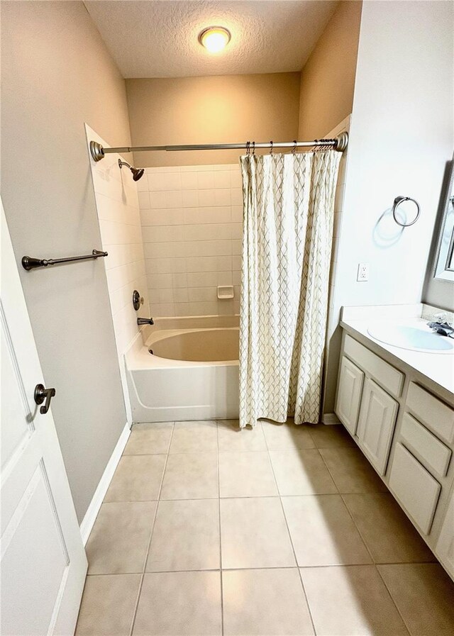 3128 Bayshore Oaks Dr, Tampa, FL 33611 - bathroom featuring a textured ceiling, tile patterned floors, shower / bath combo, and vanity