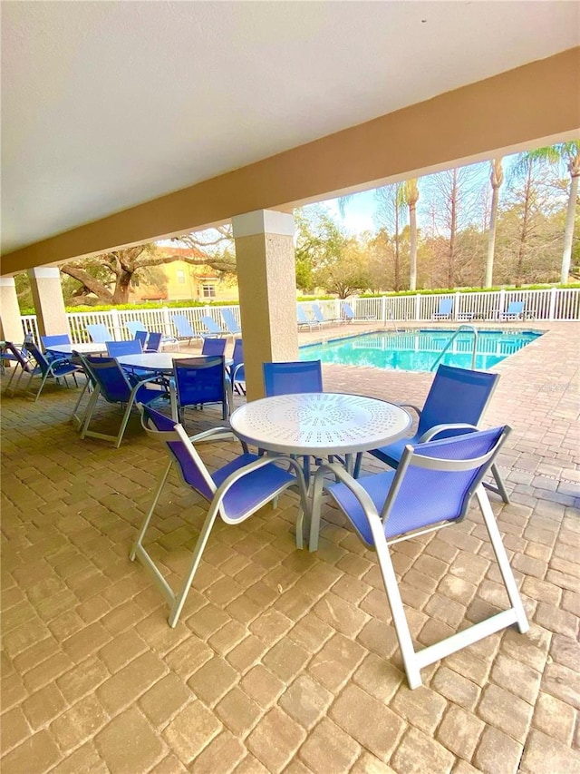 3128 Bayshore Oaks Dr, Tampa, FL 33611 - community pool featuring a patio, a fenced backyard, and outdoor dining space