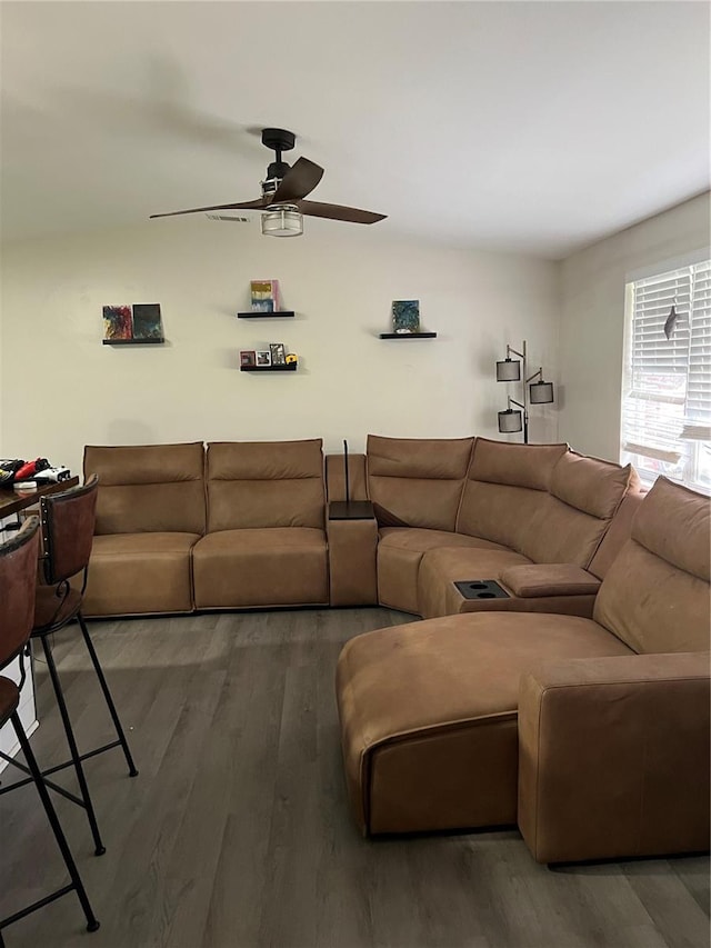 living area with a ceiling fan and wood finished floors