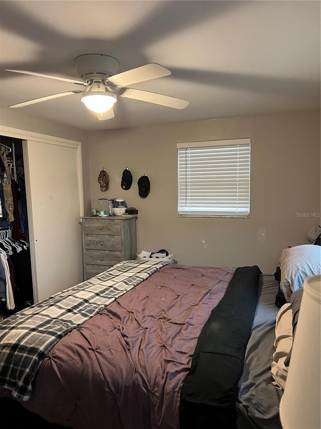 bedroom with a ceiling fan and a closet