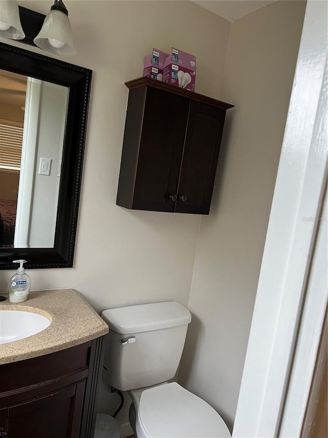 bathroom featuring vanity and toilet