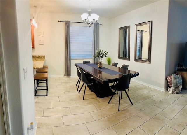 dining space with a notable chandelier, light tile patterned flooring, and baseboards