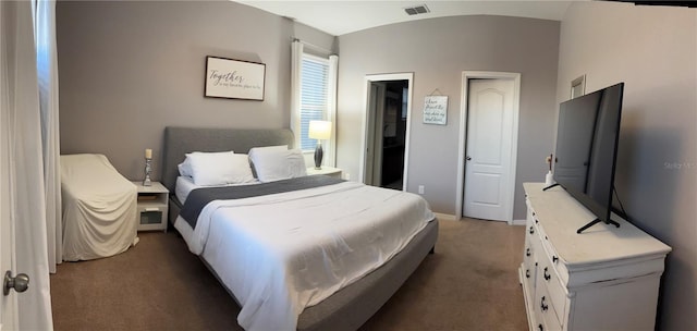 bedroom with baseboards, visible vents, vaulted ceiling, and carpet flooring