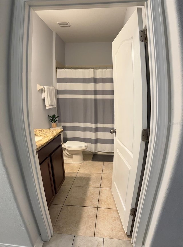 bathroom with visible vents, a shower with shower curtain, toilet, tile patterned flooring, and vanity