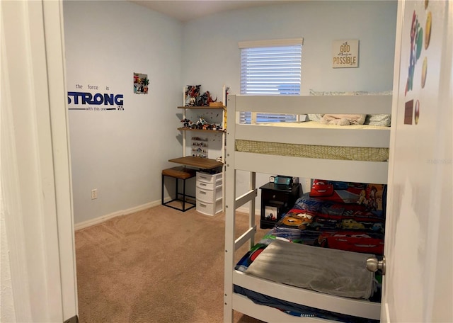 carpeted bedroom featuring baseboards